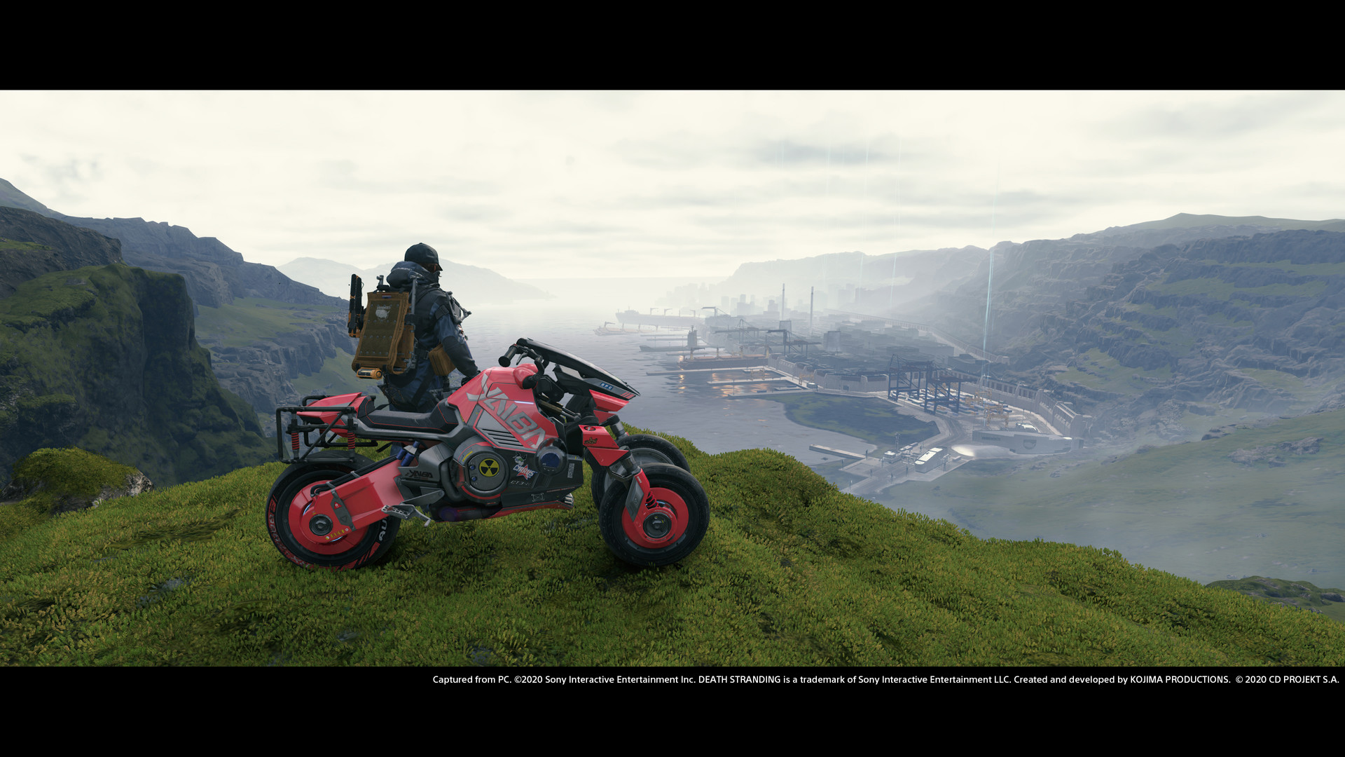 Sam Bridges sur sa moto observe une installation UCA en contrebas dans Death Stranding